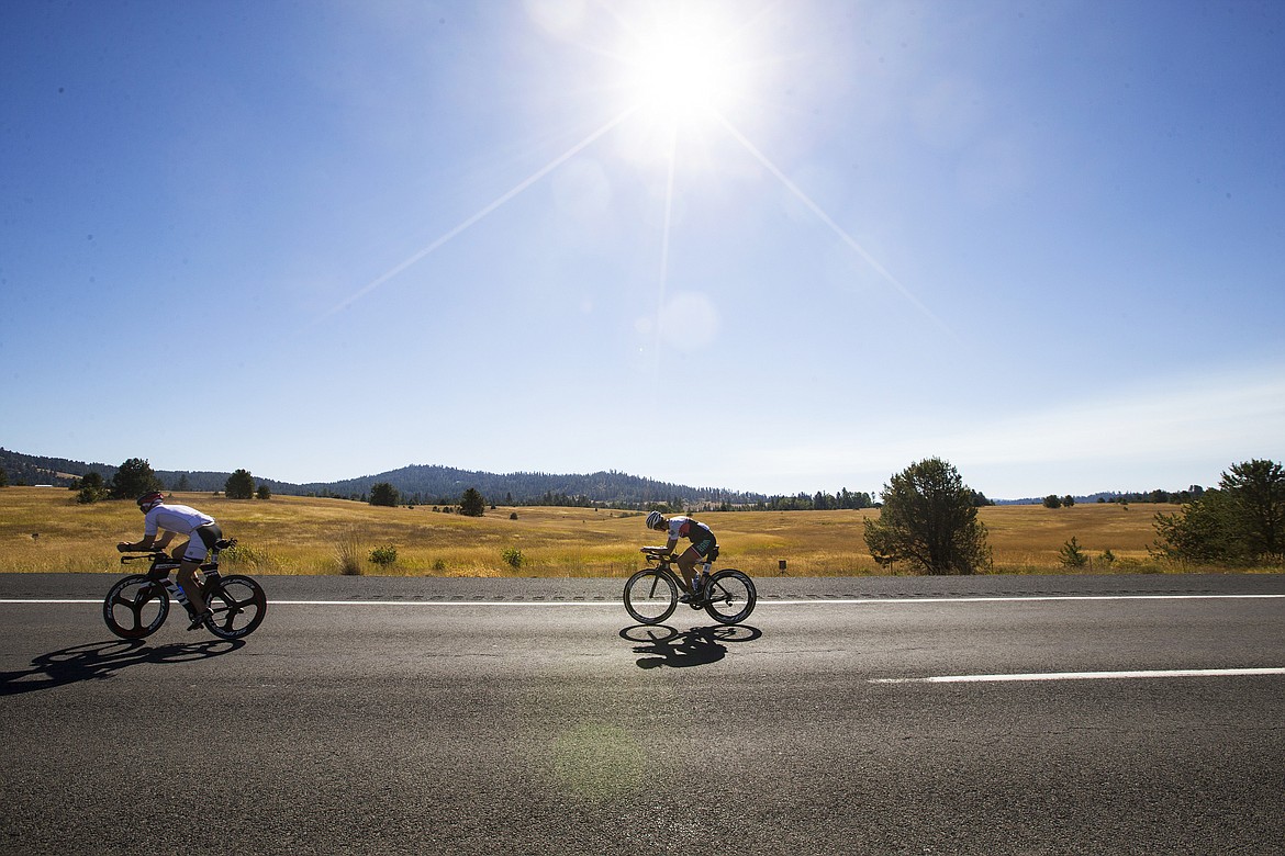 LOREN BENOIT/Press

Athletes bike back to Coeur d&#146;Alene during a hot summer day. Ironman day temperatures reached 92 degrees.