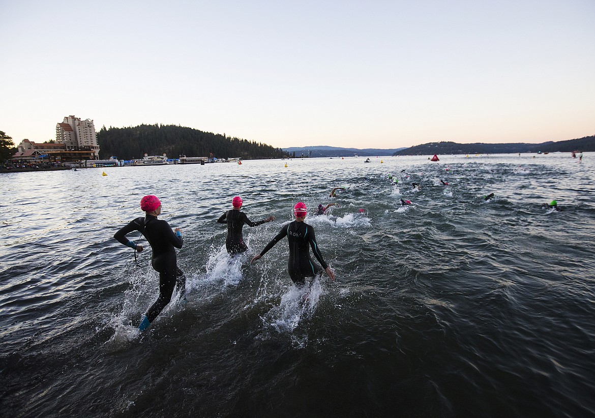 LOREN BENOIT/Press

Female Ironman Coeur d&#146;Alene athletes rush into the water for the 2.4 miles swim Sunday morning.