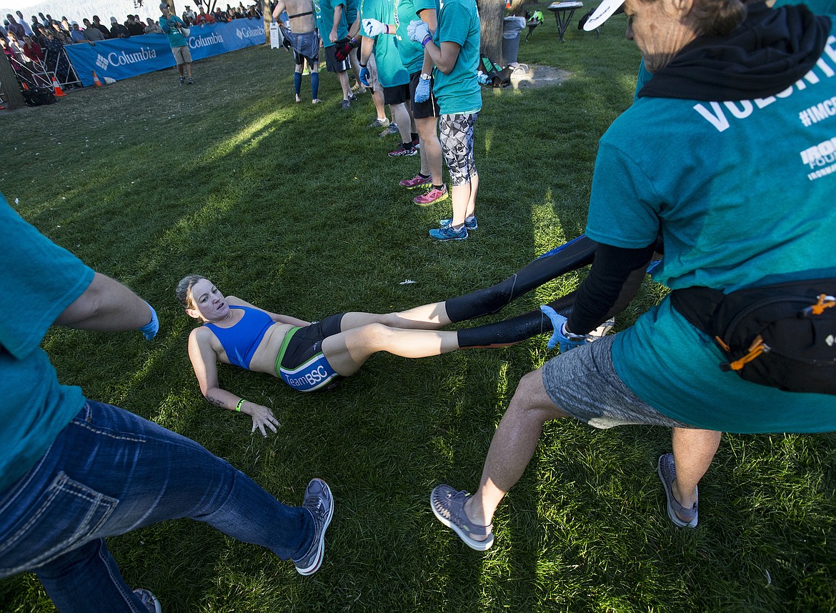 LOREN BENOIT/Press

Wendy Watson helps remove Krista Lapan&#146;s wet suit in the swim to bike transition area at City park during Ironman Coeur d&#146;Alene on Sunday.