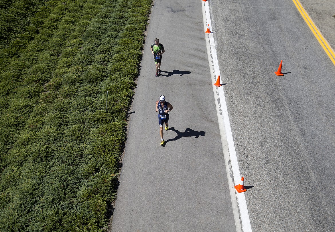 LOREN BENOIT/Press

Michael Van Skaik, front, and Joshua Fishkin run near the Terrace Condos during Ironman Coeur d&#146;Alene.