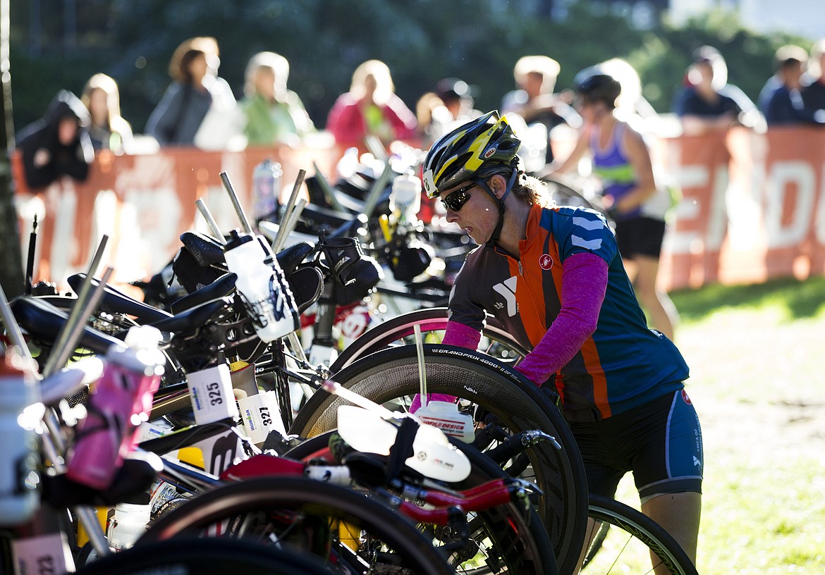 LOREN BENOIT/Press

Gael Gebow, of Everett, Washington removes her bike from the bike rack during Ironman Coeur d&#146;Alene on Sunday.