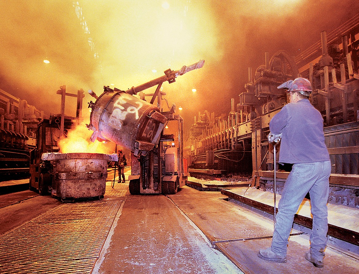 A worker watches as molten aluminum is transferred at Columbia Falls Aluminum Co. in 2001. The plant, shuttered since 2009, was permanently closed in 2015. (Inter Lake file photo)