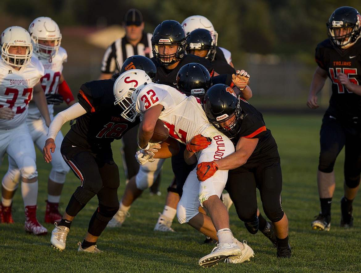 The Post Falls defense gang tackles Sandpoint&#146;s Dillan Mitton for the loss during Friday night&#146;s game. The Trojans defeated the visiting Bulldogs 56-12. 
LOREN BENOIT/Press