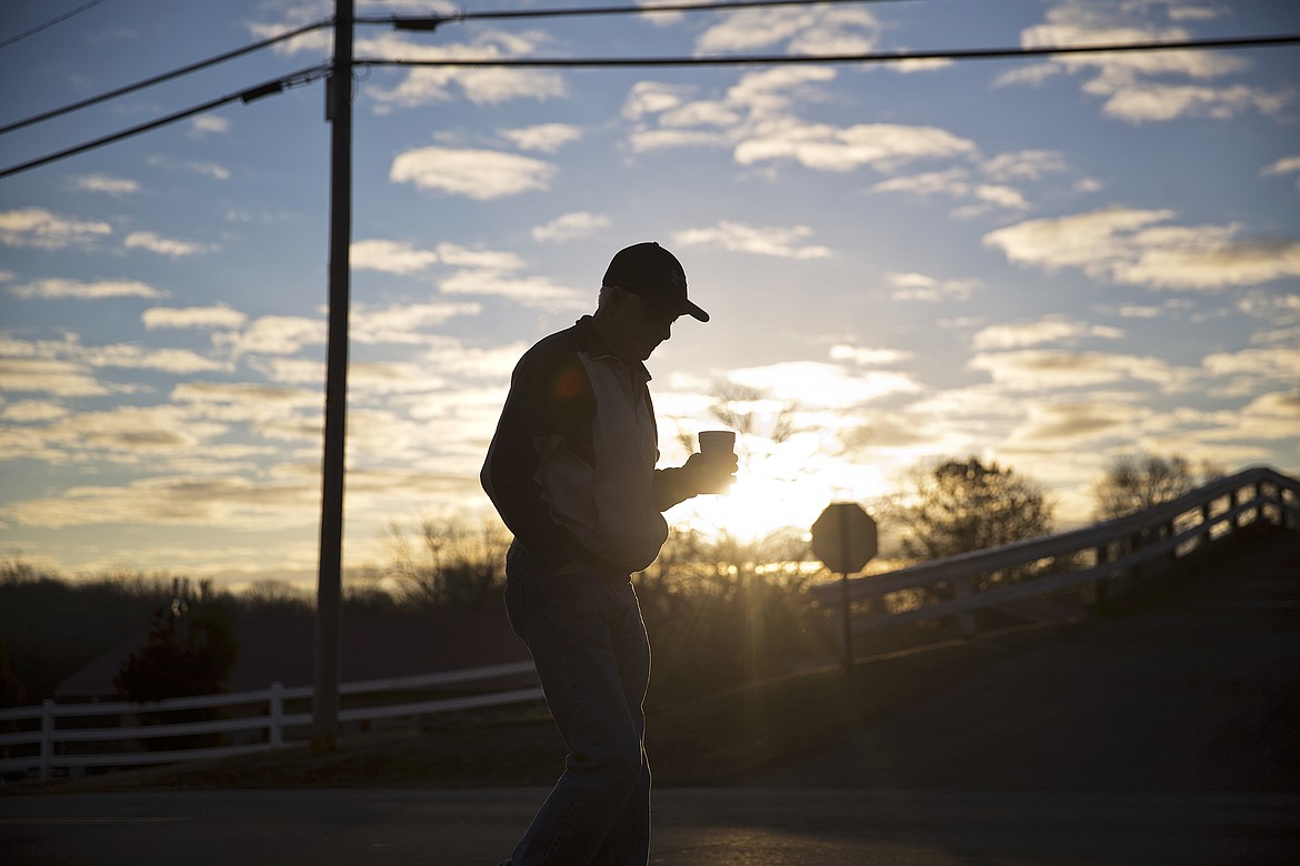 AP Photo/David Goldman
Billy Thompson walks with a cup of coffee after dropping his car off for repair as the sun rises in Lula, Ga., on Jan. 12.