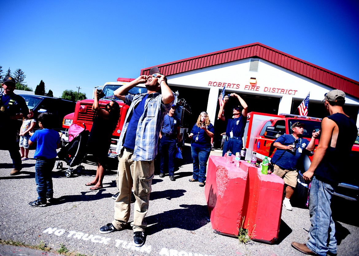 Volunteers at the Roberts Fire District station watch the eclipse on Monday, Aug. 21. The Fire District has only 15 volunteers all of whom were on duty on Monday. Many of the volunteers had taken vacation time from their regular jobs so they could be at the station and on call during the eclipse. Firefighters had been meeting with the local law enforcement community for more than a year planning and preparing for the influx of visitors.