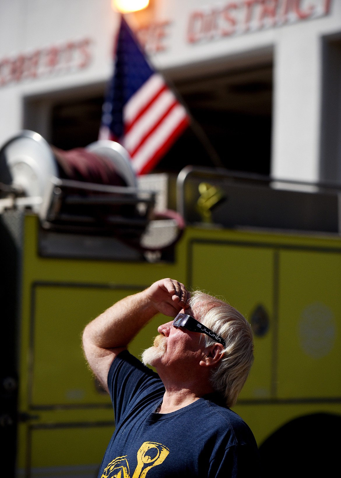 Al Tays of Whitefish stands near the Roberts Fire District station as he watches the moon begin to pass in front of the sun. Seeing totality was a &#147;bucket list&#148; item for Tays.