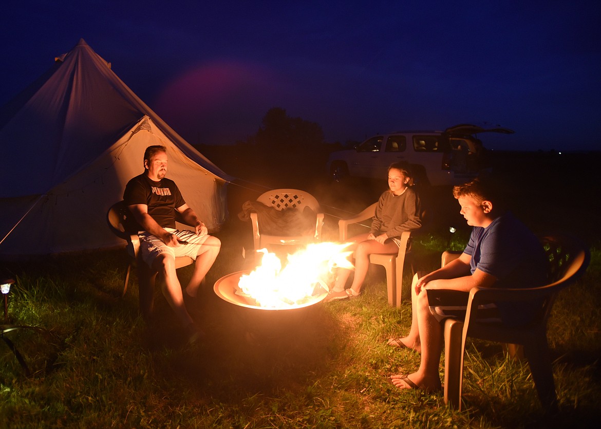 Clark Cunzler of Logan, Utah sits with his daughter Mykell, 13, and son Ethan, 11, at a campsite a mile from Roberts, Idaho on Sunday evening, August 20. Cunzeler clearly remembers being 12 years old and watching the eclipse in 1979 through a welding helmet. He remembers wondering who he would be in 2017, where he would live, what his life would look like. On Sunday morning he and his wife decided to make a last minute trek up to Idaho to see the eclipse with their kids.(Brenda Ahearn/Daily Inter Lake)