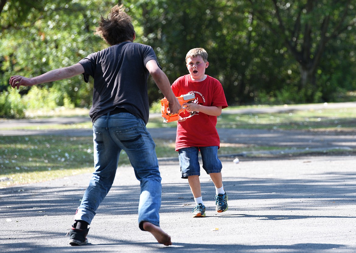 Dane Gaddis yells for help as he is attacked by a Zombie during the Zombie Survival Camp on Wednesday. (Aaric Bryan/Daily Inter Lake)