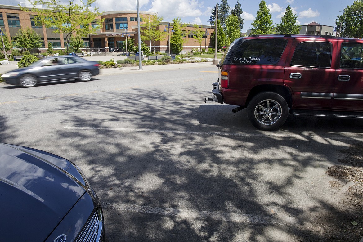 LOREN BENOIT/Press
The city of Post Falls will hold an open house on its proposed Transportation Master Plan today from 11:30 a.m. to 2 p.m. and 4:30 to 6:30 p.m. at City Hall, shown in the background. The city hopes to construct more on-street parking, such as these spots on Fourth Avenue, on other city center streets and rights of way. As more businesses explore locating to the city center, providing ample parking has become a priority to the city.