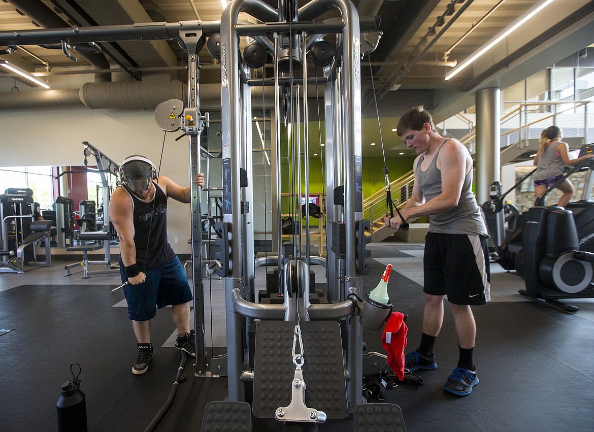 LOREN BENOIT/PressNorth Idaho College students Devon Cole, left, and Mason Taylor workout Wednesday morning at the new Student Wellness and Recreation Center.