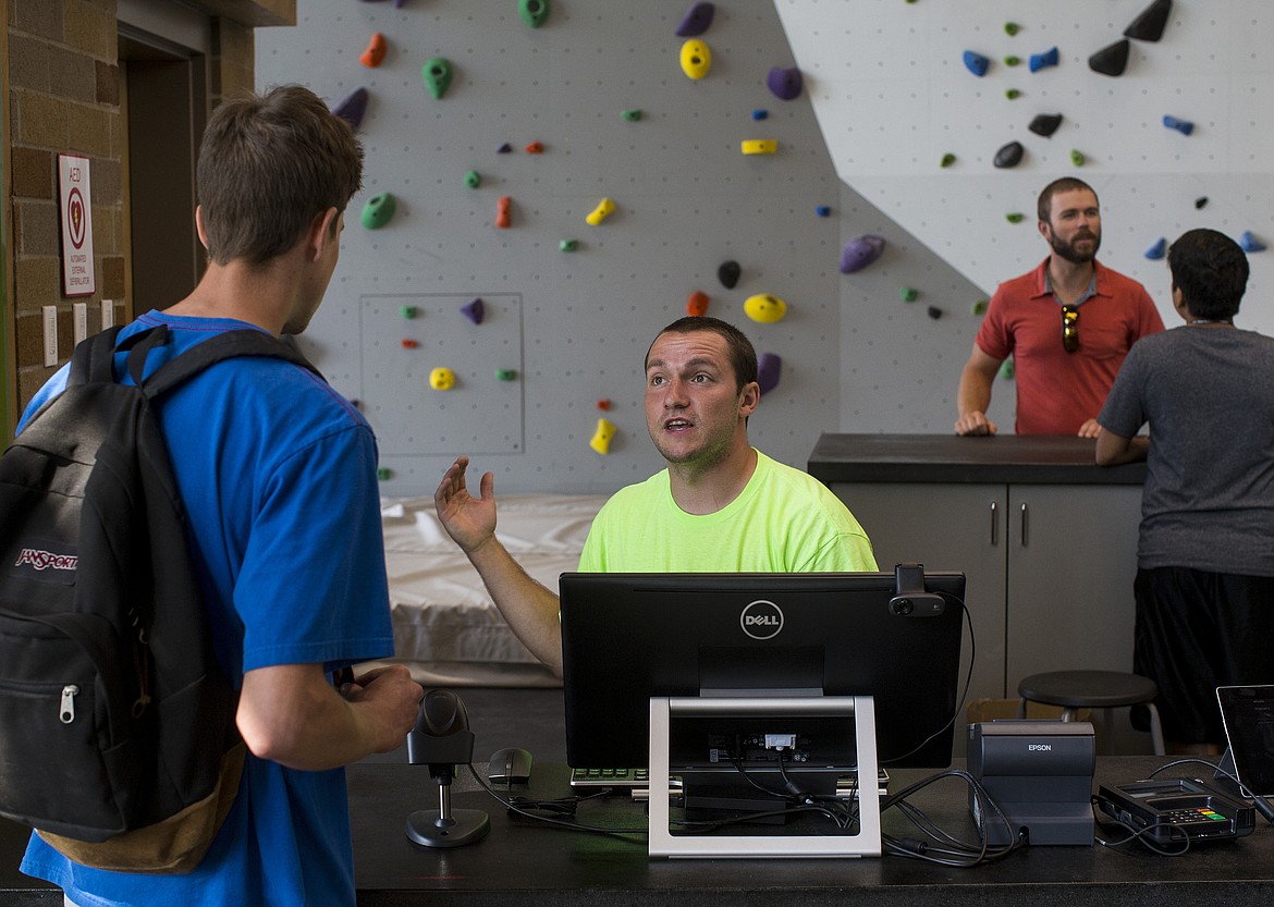 LOREN BENOIT/PressStudent Wellness and Recreation Center assistant Mac Phillips helps North Idaho College student Jared McEvers with his membership Wednesday morning at NIC.