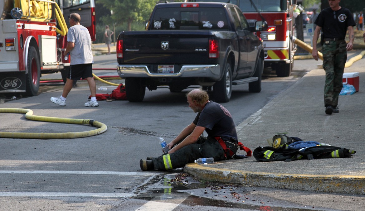 Even heros need to be able to breathe. Firefighter Mike North takes a rest and grabs some water.