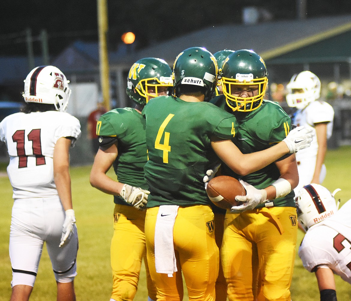 Teammates cheer on Mark Anderson after scoring the Bulldogs' lone touchdown during Friday's loss to Hamilton.