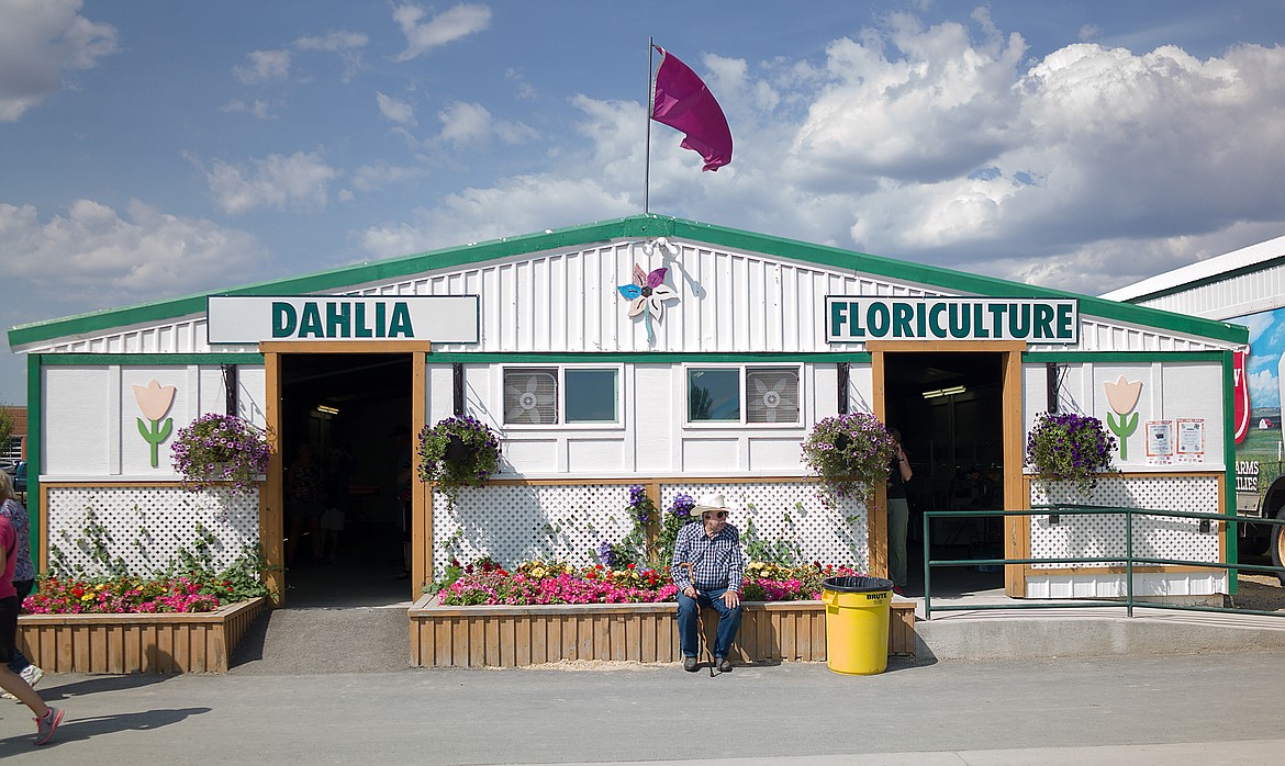 Dale Schneider takes a flowery break at the Northwest Montana Fair last week.