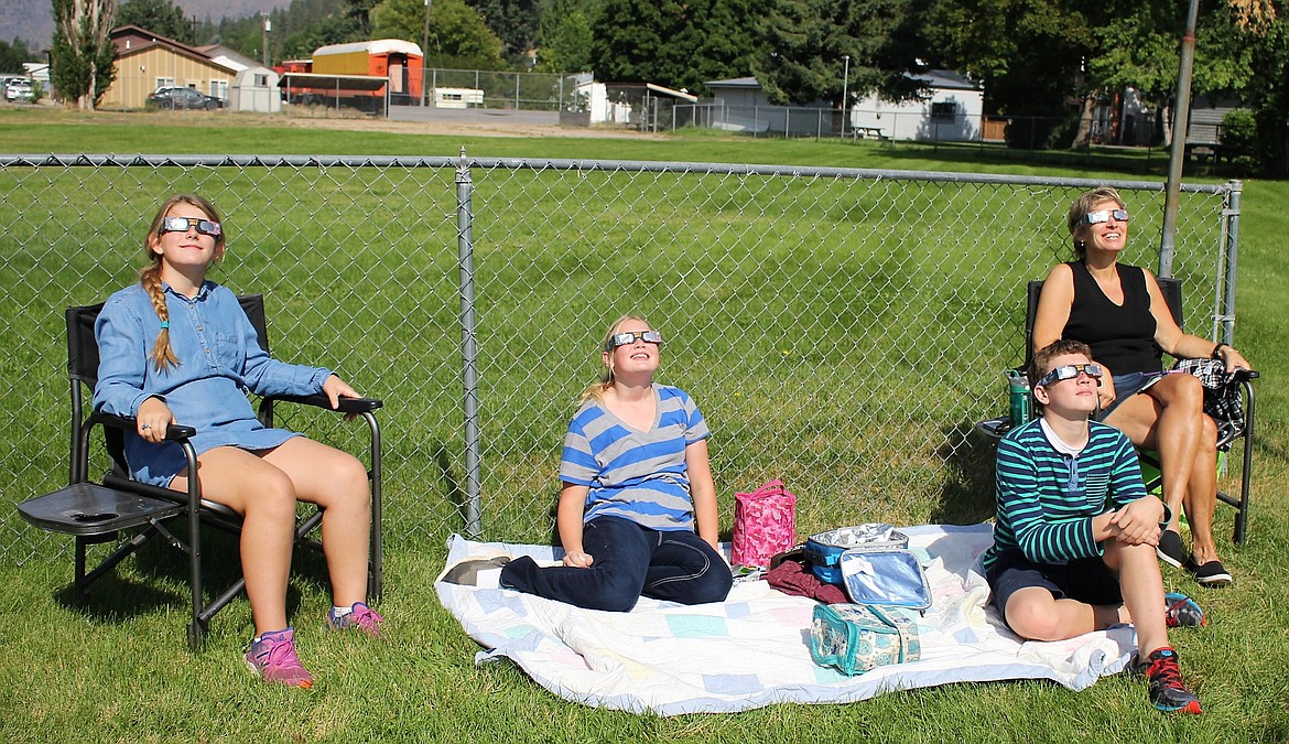 Ryan Evans, Rudy Lynn Evans, Alexei Stalpaert and Shannon Stalpaert traveled from Huson to enjoy the eclipse during festivities at the Alberton Community Center on Aug. 21. (Kathleen Woodford/Mineral Independent)