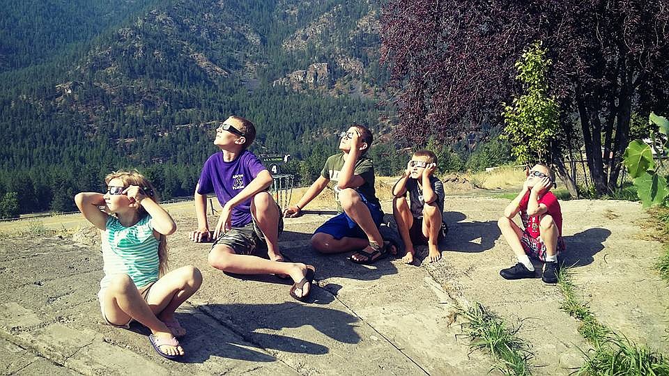 Members of the Bean family catch a glimpse of the solar eclipse in Alberton on Monday, Aug. 21. (Photo courtesy of Ceciley Bean).