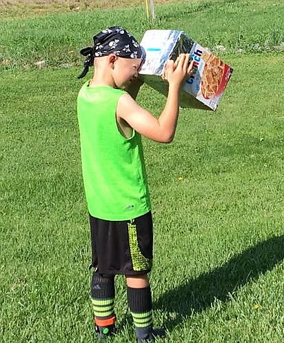 Luca DiGiando, 7, looks at the eclipse through a homemade viewer using a giant cereal box. (Photo courtesy of Darlene Kuprienko Jasper).