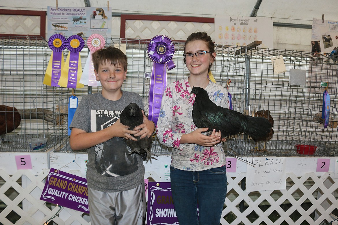 Logan and Lillian Brinkman pose with their award winning chickens, sharing in depth knowledge about the breeds, history and purpose of their poultry friends.