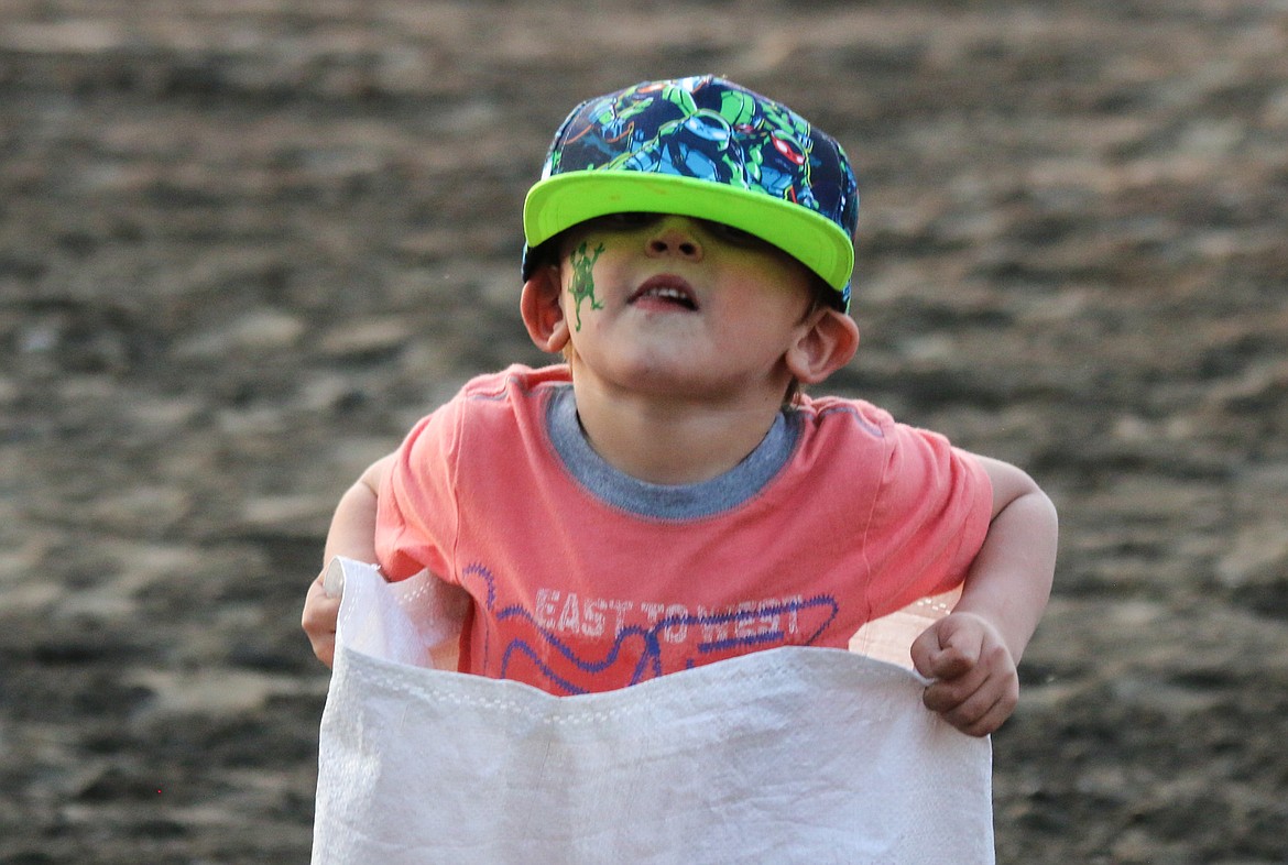 Photo by Mandi Bateman
A loose fitting hat became a bit of a problem for this hopper in the Gunny Sack Race.