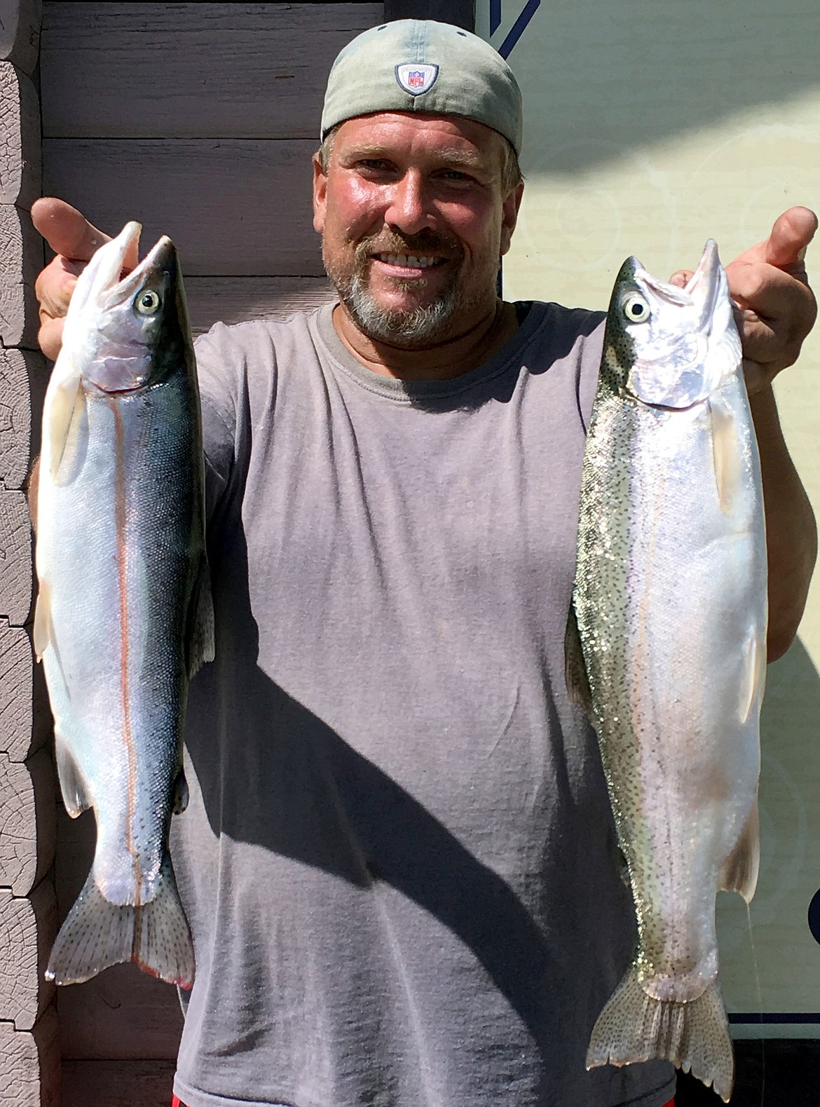 Pete Fisher photo - Dave Schultz of Moses Lake with two nice trout he caught trolling crankbaits along Medicare Beach.