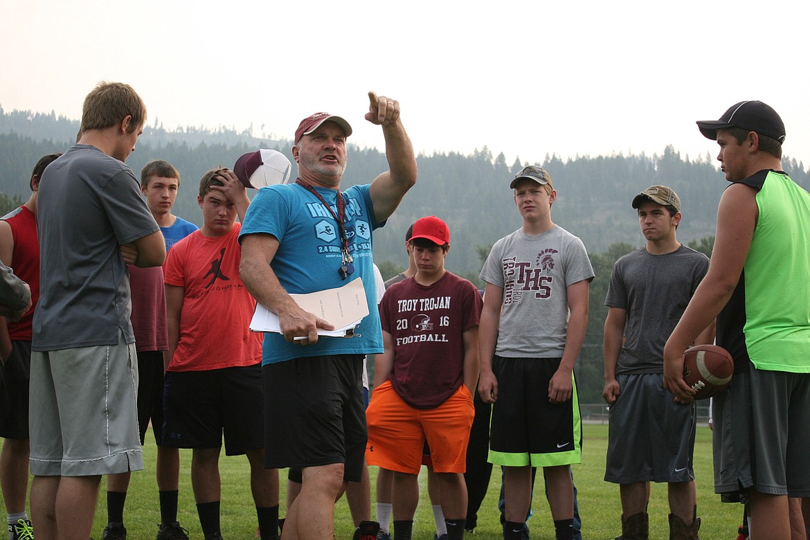 New Troy High School head football coach Greg Jonsen, left of center, oversees the team&#146;s first practice Aug. 11. (Elka Wood/The Western News)
