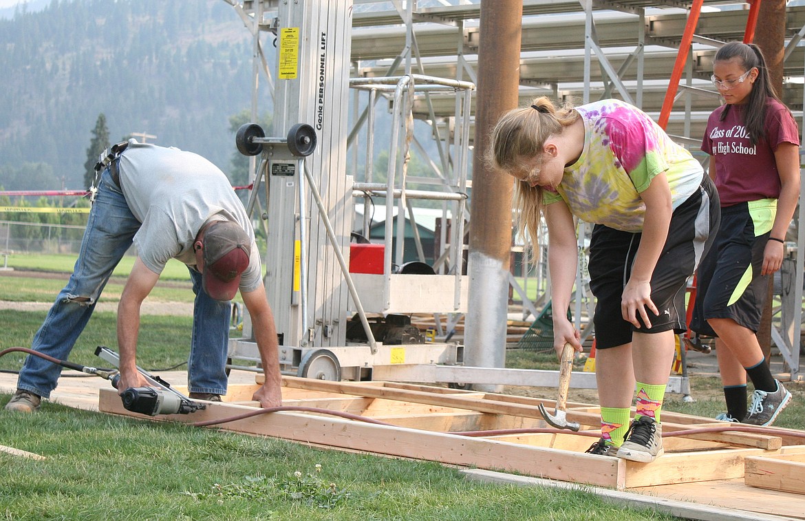 Maintenance manager Keith Haggerty, left, Isabel Ramirez and Hailey Hoban put the finishing touches to a platform for the new press box on Friday, Aug. 11. The new box will be 24 feet across, while the old one, built in the mid-seventies, is 18 feet across, Haggerty said. (Elka Wood/The Western News)