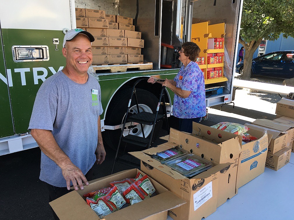 Courtesy photo - Todd Kennedy, Second Harvest of the Inland Northwest in Spokane, and Director of the Royal City Food Dorothy Lee were among several people who volunteered time to unload and distribute over 6,800 of fresh food and grocery items for Second Harvest Mobile Food Bank program.