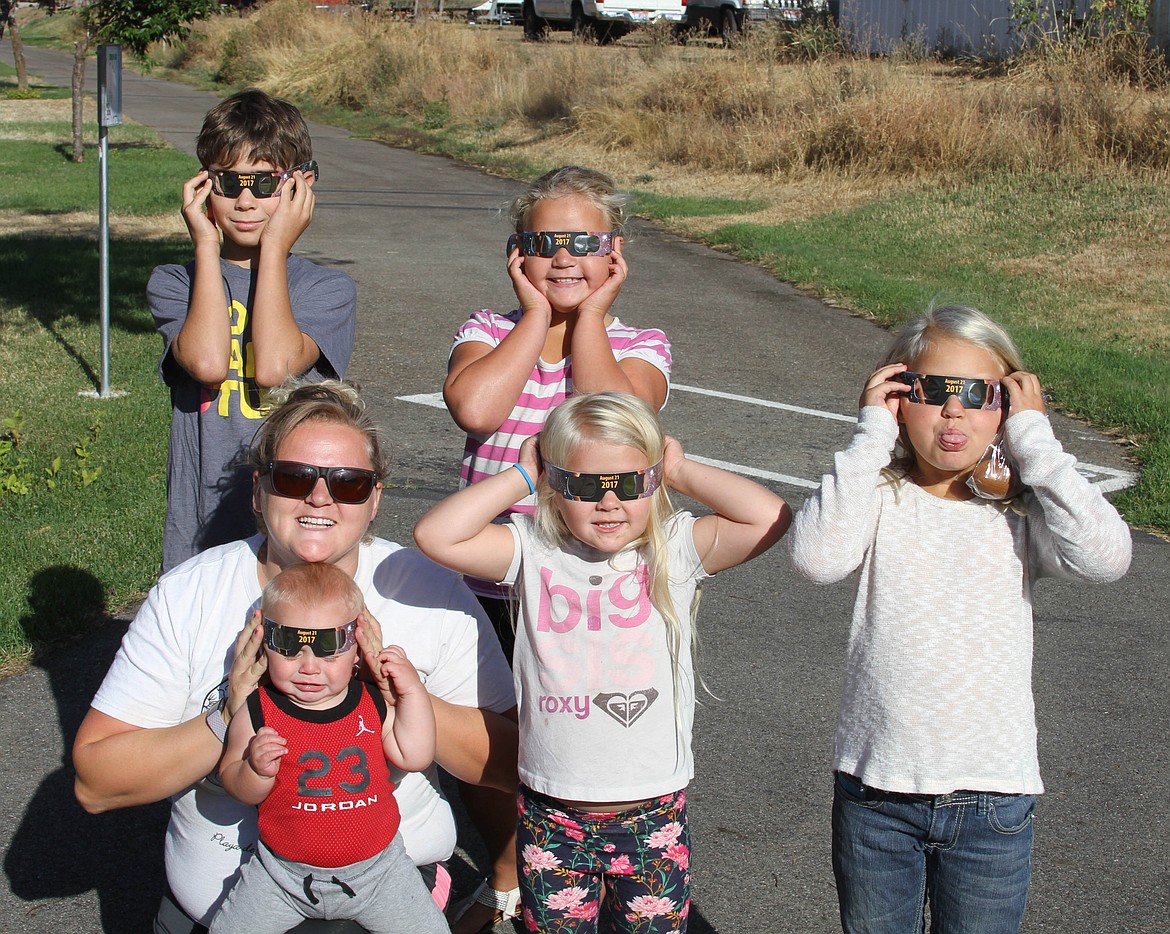 Photo by JOSH MCDONALD
Eclipse Kids- Kiley Hennings and her children Harley, Gracie, Brailey, and baby Daxon stand with friend Radley Groth (top left) after receiving their eclipse glasses. Daxon wasn't as excited as everyone else was.