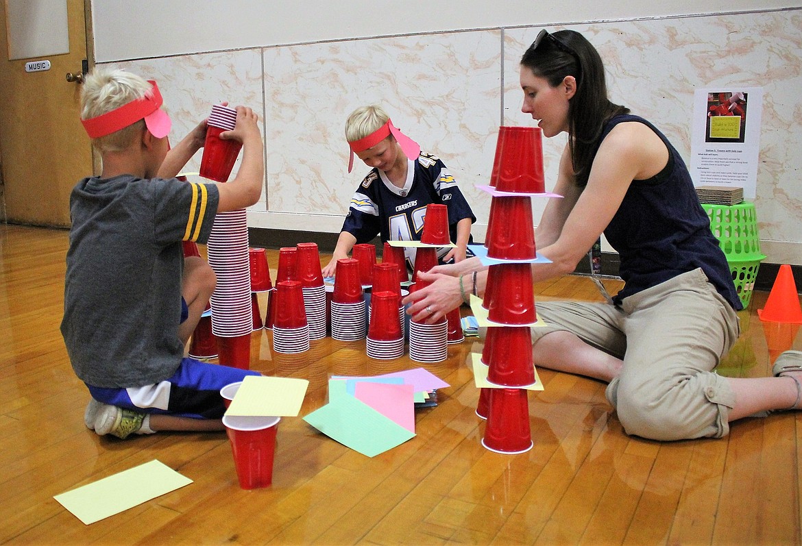 Joshua and Jonathan Sutherland build a fort out of red solo cups with Josie Hayes-Johnson in the Alberton School cafeteria as part of Montana PBS &#147;Building Communities&#148; event. (Kathleen Woodford/Mineral Independent)