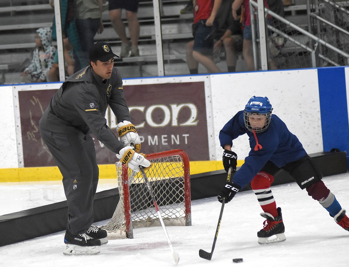 Las Vegas Golden Knights Alex Tuch works with a young player during a clinic at Stumptown Ice Den Wednesday evening.