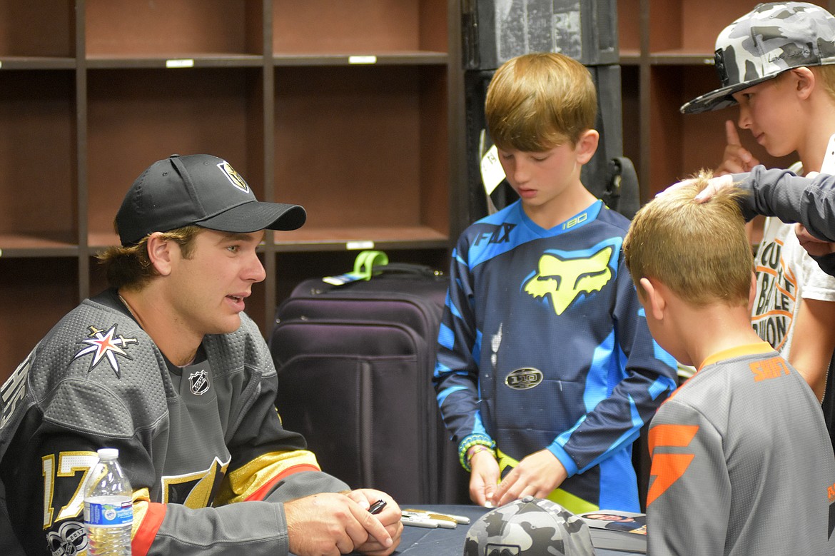 Las Vegas Golden Knight Jake Bischoff speaks with Isaiah, Oliver and Jack Billyard, all of whom attended Wednesday night's clinic at Stumptown Ice Den.