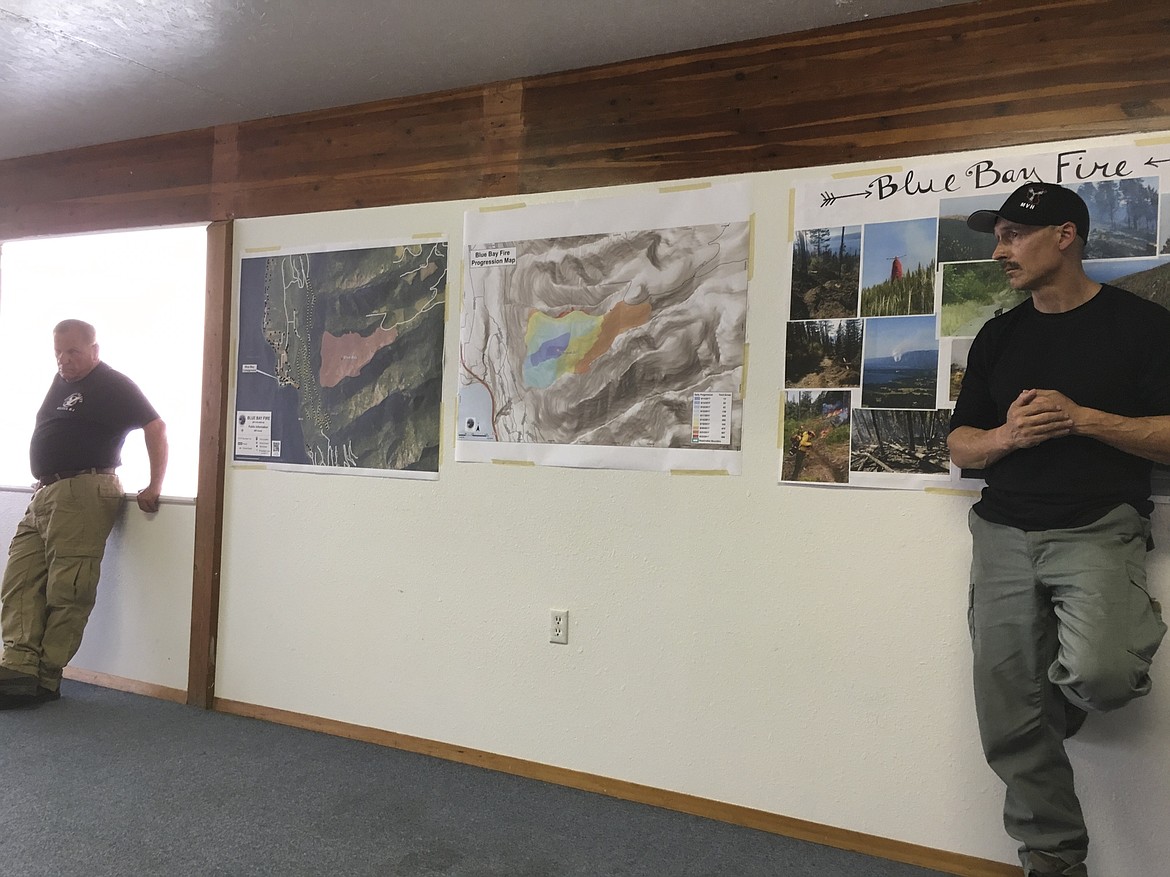 Bob McCrea, left, and Ron Swaney, both of the Division of Fire, listen as residents ask questions during a public meeting regarding the Blue Bay fire Monday evening. (Ashley Fox/Lake County Leader)