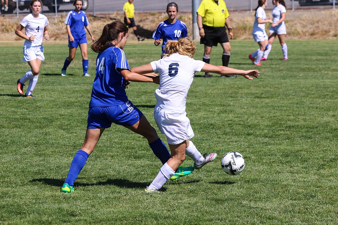 Photo by Mandi Bateman
Bonners Ferry's Prarie Plaster, right, fends off a Stillwater Christian opponent to gain possession in a recent home match.