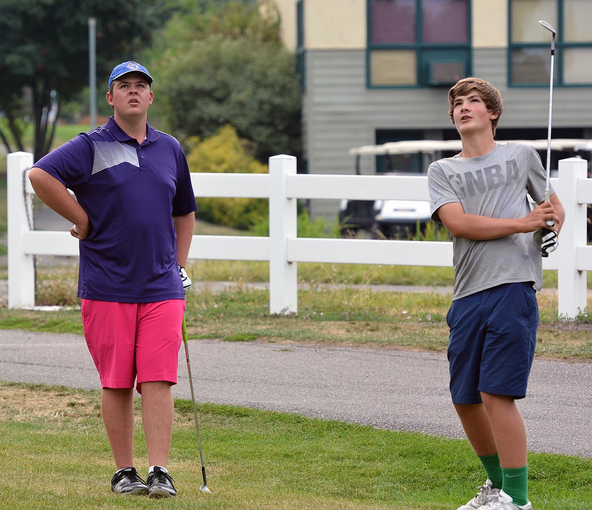 POLSON PIRATE golfer Matt Hobbs (right) works with Carson McDaniel on chipping Monday afternoon at the Mission Bay Golf Course. (Jason Blasco/Lake County Leader)