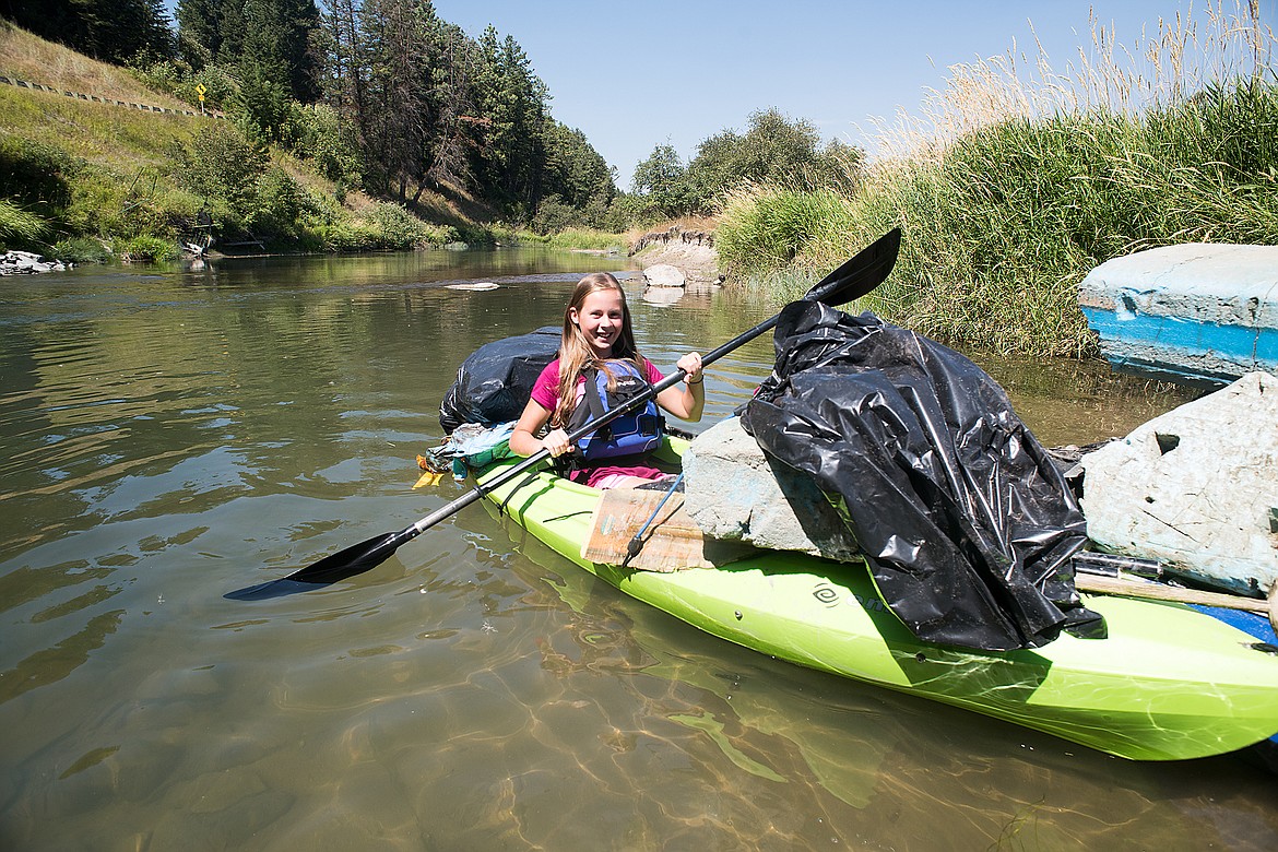 Sarah Downs with her kayak loaded with garnage and debris from the Whitefish River recently.