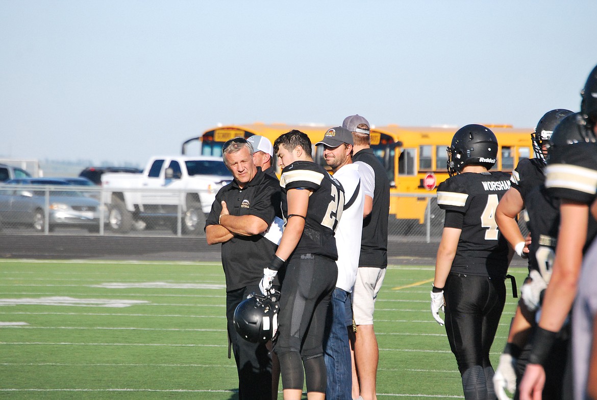 Bob Kirkpatrick/The Sun Tribune - Coach Allred talks strategy with a Knight on the sidelines.