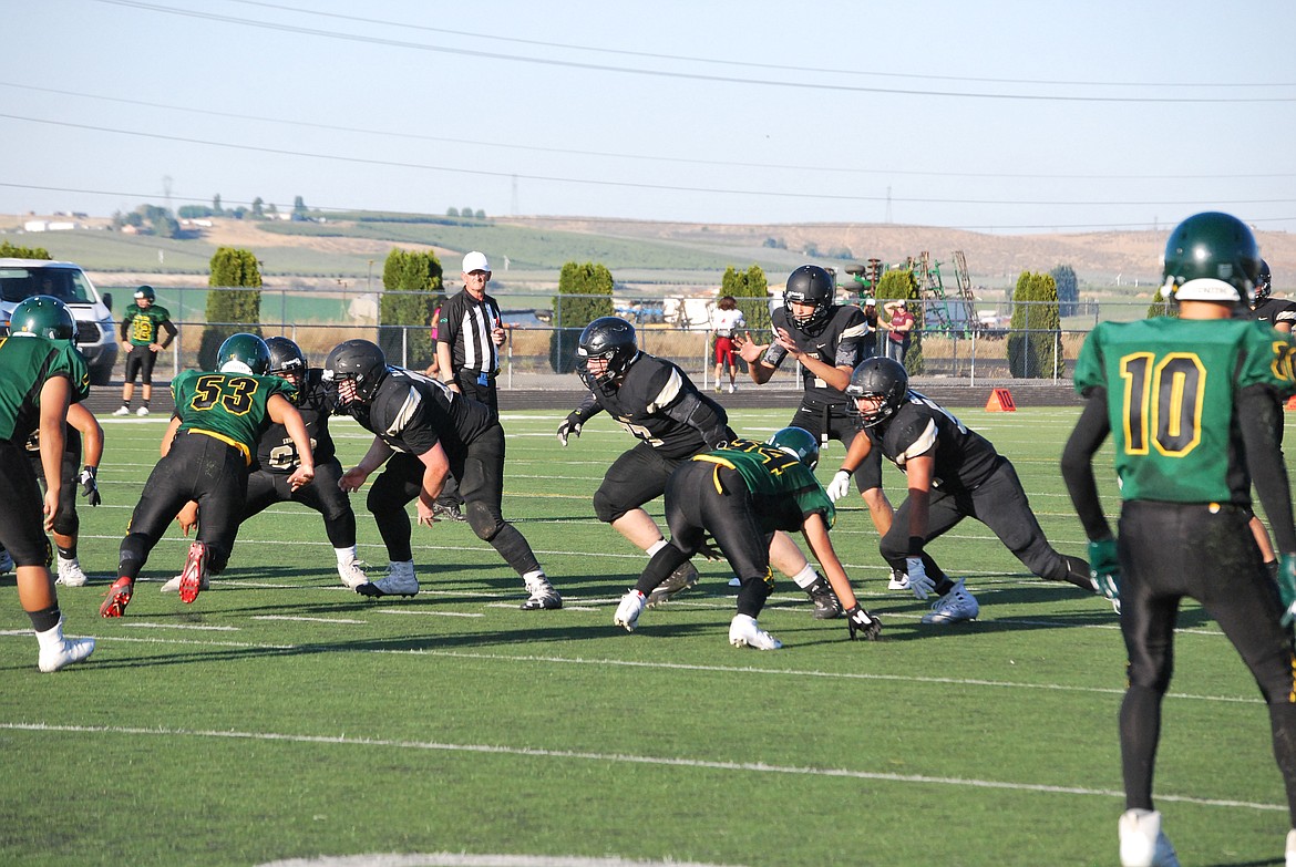 Bob Kirkpatrick/The Sun Tribune - Sophomore QB Sawyer Jenks readies to receive the snap in the scrimmage with Quincy.