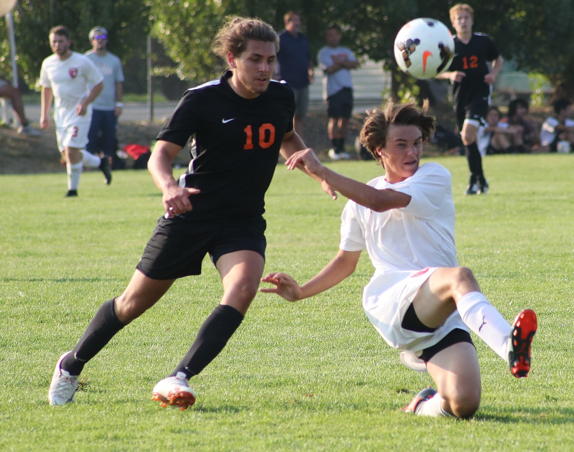 (Photo by ERIC PLUMMER)
Senior defender Max Edmundson pokes the ball away from a Post Falls player in the Bulldogs&#146; 3-1 win.