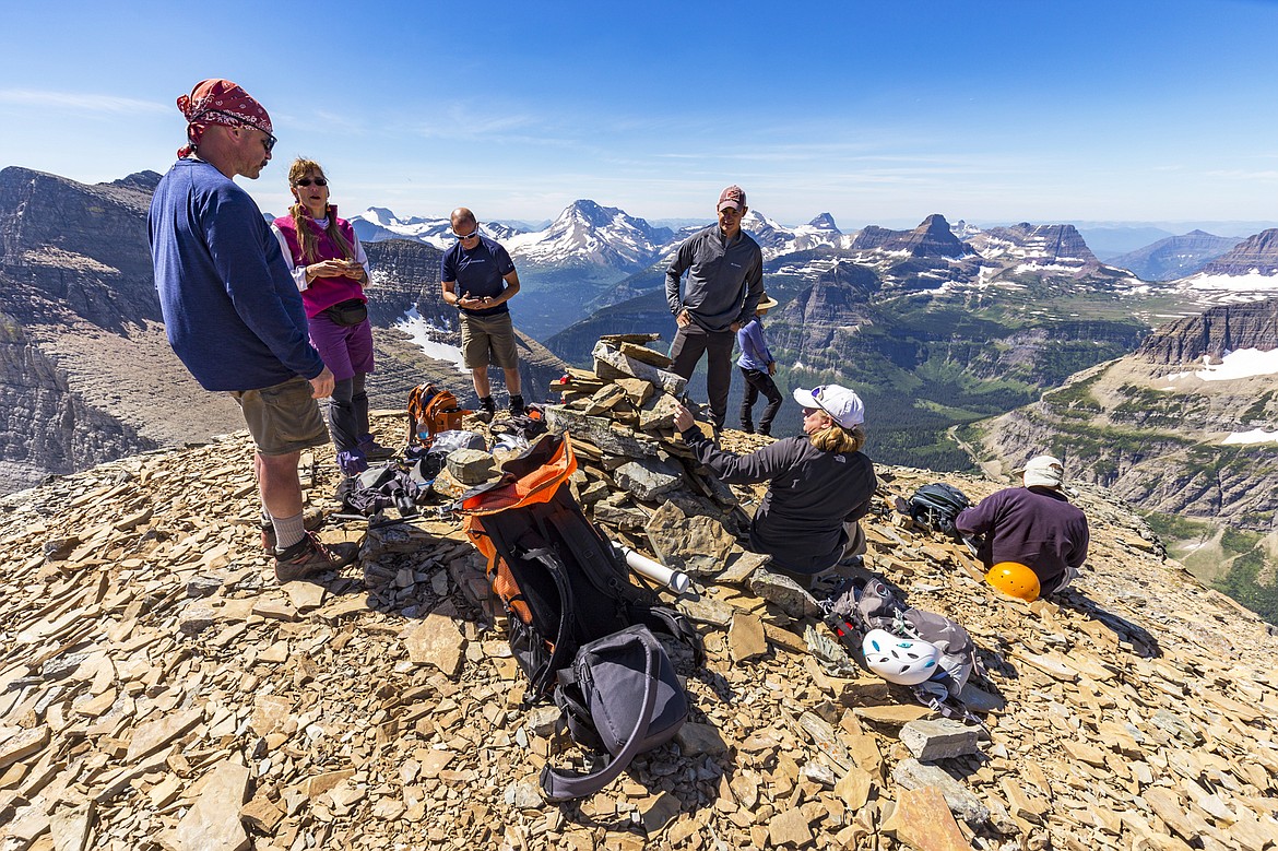 Glacier Mountaineering Society members relax at the summit of Matahpi Peak in Glacier National Park.