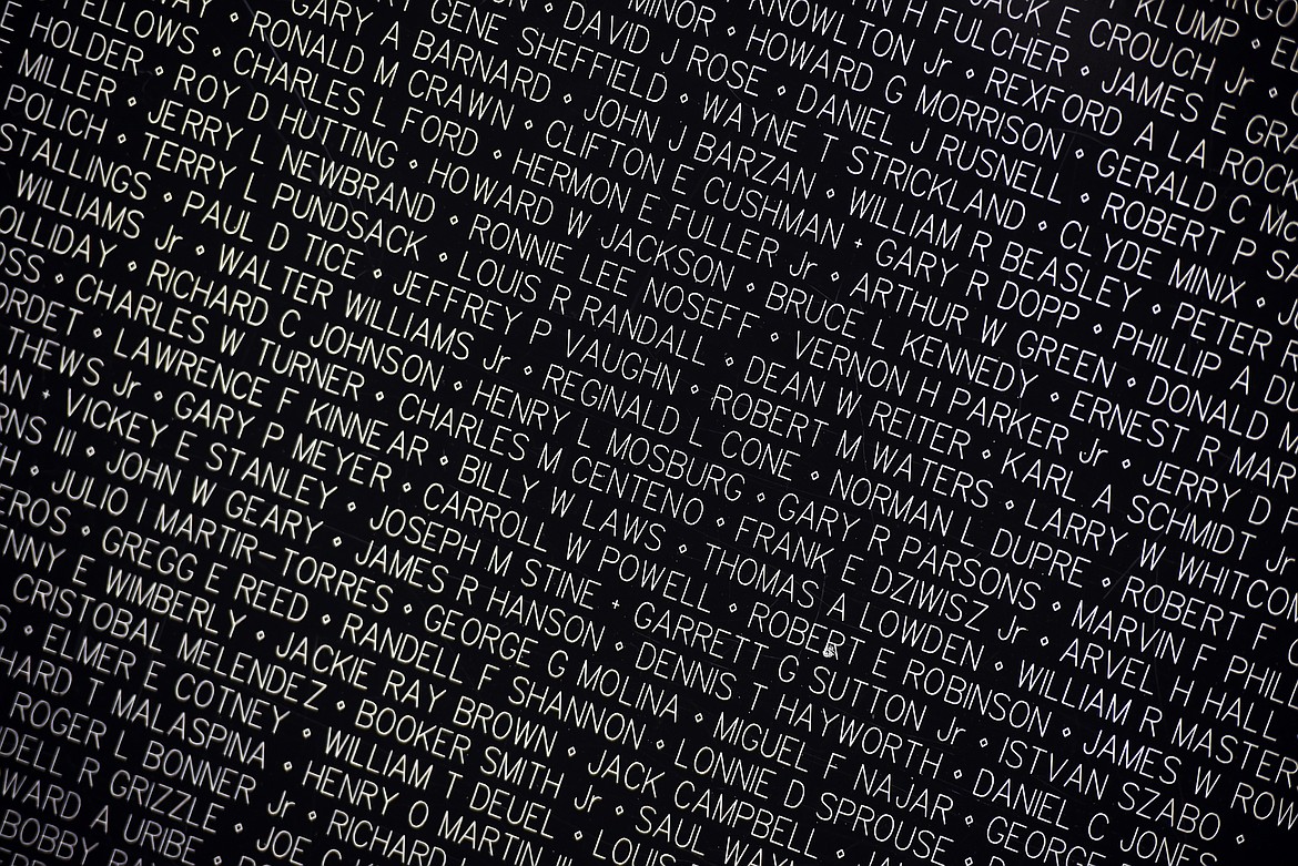 A detail photograph of names etched into the aluminum panels that make up the replica of the Vietnam Veterans Memorial in Washington D.C. The wall is made up of 100 aluminum panels. Due to the more delicate nature of the replica wall, etchings are not permitted. However, attendees who want an etching can give their name an information at the visitors tent and they will be sent etchings from the memorial in Washington.