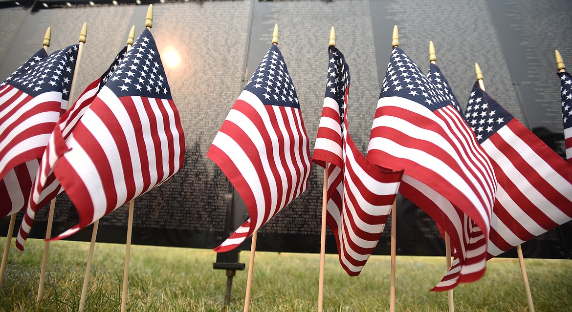 A hazy sun is reflected off The Wall that Heals on Thursday morning, September 6, in Kalispell. Today there will be two ceremonies at the wall, the opening ceremony at 10 a.m. and the closing ceremony at 4 p.m. The closing ceremony will feature a performance of Echo Taps by BJ Lupton and Gerry Schultz.(Brenda Ahearn/Daily Inter Lake)