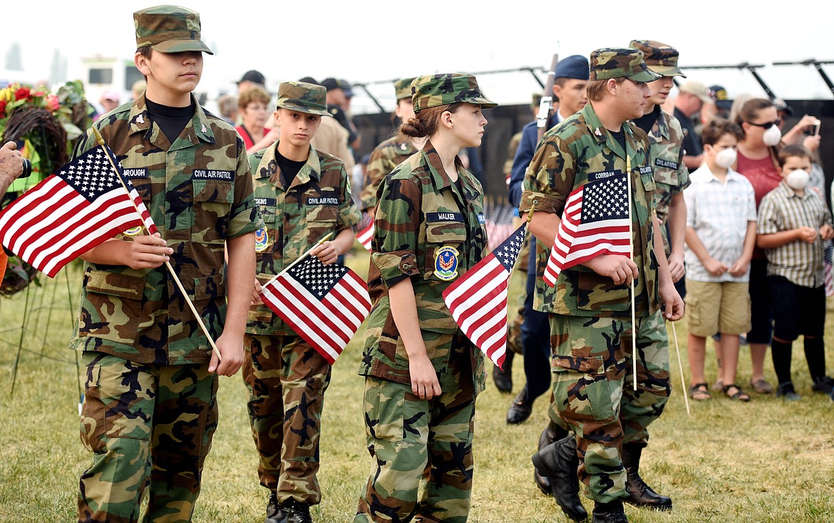 Members of the Civil Air Patrol carry flags to place at the base of The Wall that Heals following the opening ceremony on Thursday morning, September 7, in Kalispell.(Brenda Ahearn/Daily Inter Lake)