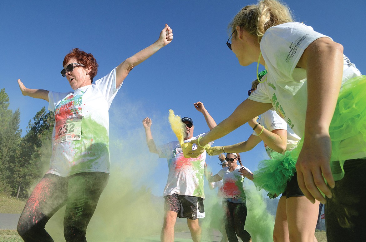 Stephanie Rohrer leads a group through a color station at the Great Fish 5k Color Run in 2016. (Whitefish Pilot file photo)