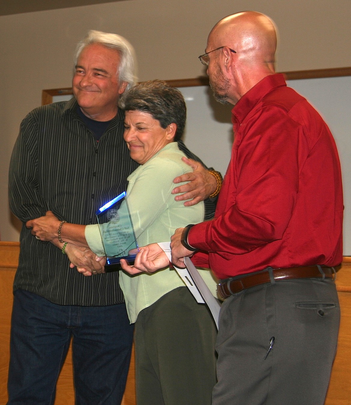 BRIAN WALKER/Press
Chaplain Jeff Cheeseborough, left, who has assisting youth in Kootenai County's juvenile justice system for 20 years, was honored by Juvenile Probation Director Debbie Nadeau, Juvenile Detention Director J.T. Taylor and others on Tuesday.