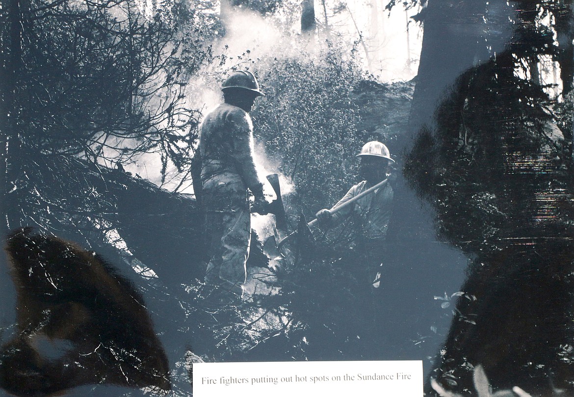 (Photo by CAROLINE LOBSINGER)A photo of a picture at the Sundance Fire 50th anniversary commemoration. The photograph shows firefighters putting out a hot spot on the Sundance Fire in August or September of 1967.