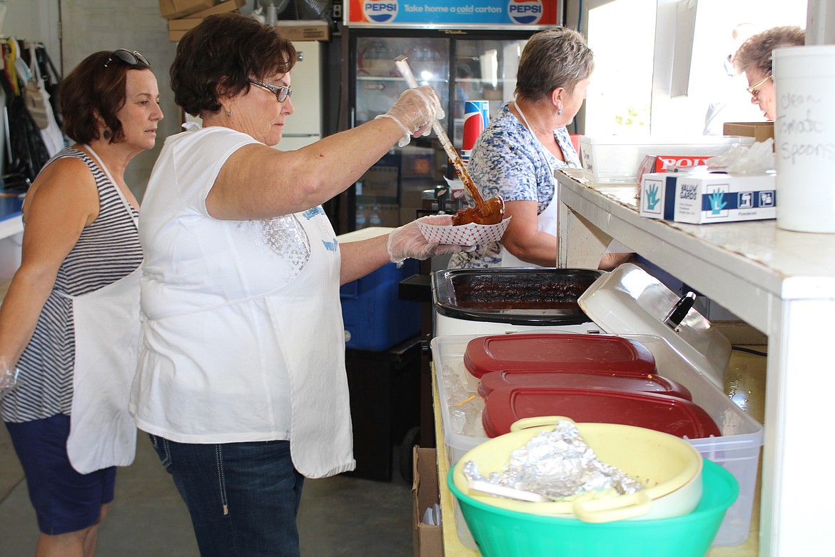 File photo
Workers at the Sacred Heart Catholic Church booth prepare their world-famous (or at least Adams County-famous) spoon tacos at the 2016 Adams County Fair.