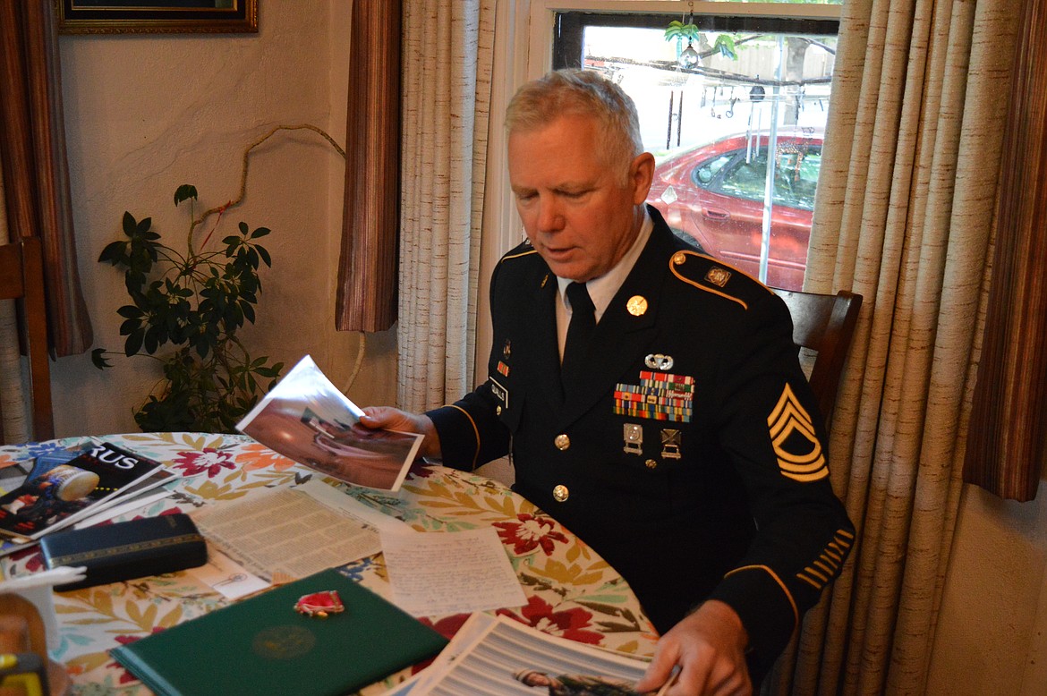 Master Sgt. Gary Qualls, an Army journalist from Kalispell, goes through old photos and articles at his mother&#146;s house in Kalispell.
(Mary Cloud Taylor/Daily Inter Lake)