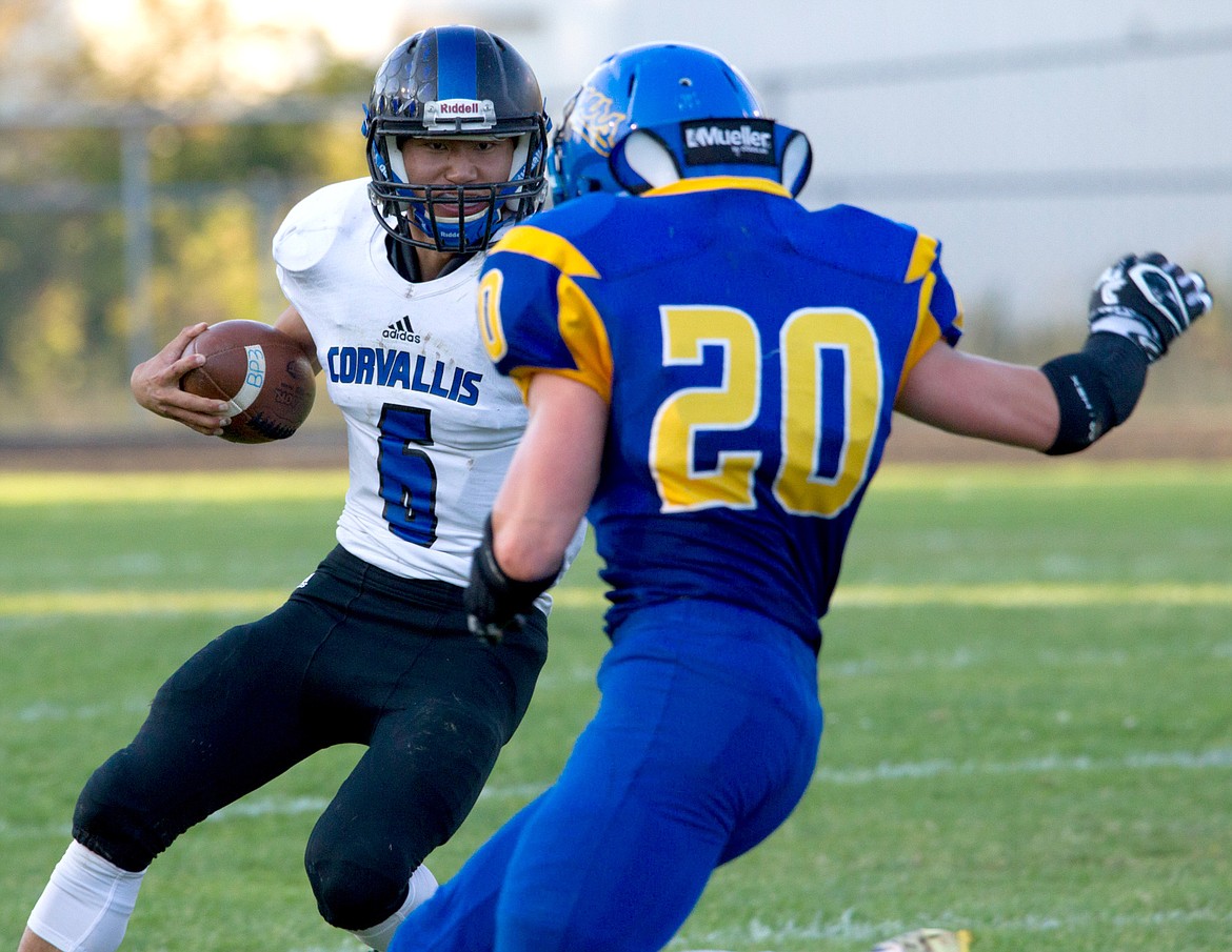 Libby&#146;s Kaine Young puts the pressure on Corvallis Quarterback Liang Liedle Friday in Libby.