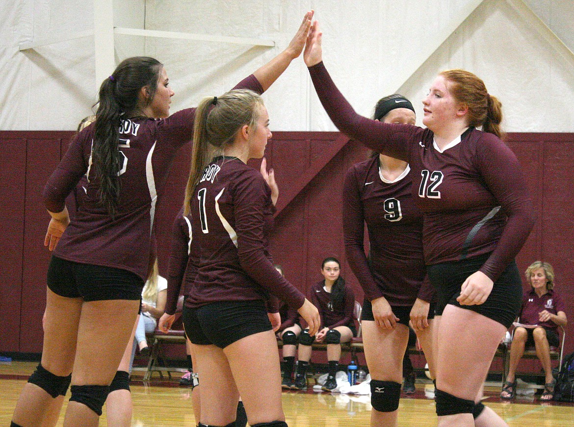 Aurora Becquart, left, high fives Montana Rice after Bequart scored a point during Saturday&#146;s winning game against Anaconda. (Elka Wood/The Western News)