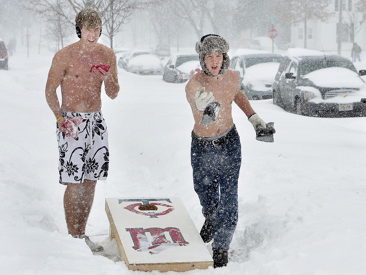 University of Wisconsin-Eau Claire students Erick Carlson, left, and Tony Tillman play a game of shirtless bean bag toss on campus in Eau Claire, Wis., on Dec. 11, 2010.